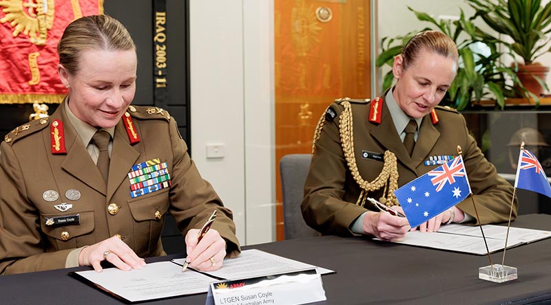 The new Chief of the Australian Army Lieutenant General Susan Coyle (left) with the Chief of the New Zealand Army Major General Rose King at Australian Army Headquarters, Canberra, sign a renewed Plan ANZAC. Photo. by Corporal Robert Whitmore.