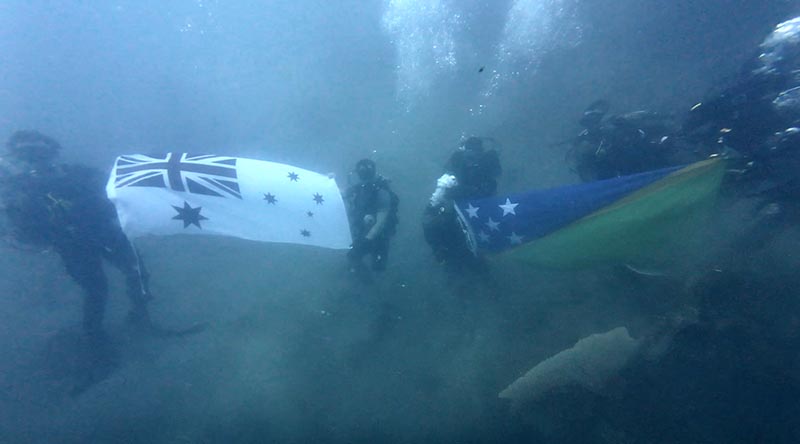 Royal Australian Navy Clearance Divers from HMAS Yarra and Royal Solomon Islands Police Force Explosive Ordnance Disposal Department personnel dive to the wreck of the Kinugawa Maru near Honiara, Solomon Islands, during Operation Render Safe. Photographer unknown.