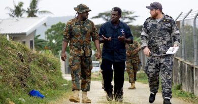 Vanuatu Mobile Force Lance Corporal Larry Qara, Royal Solomon Islands Police Force Explosive Ordnance Disposal Department Police Constable Barnabas Talo and Royal Australian Navy sailor, Leading Seaman Clearance Diver Bradley Fox discuss explosive ordnance disposal techniques at Cook Barracks in Port Vila, Vanuatu, during Operation Render Safe 26-2. Photo by Petty Officer Daniel Goodman.