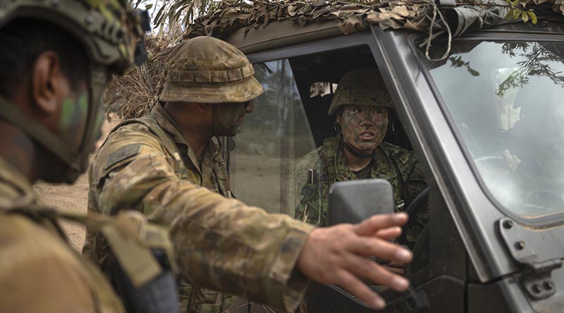 A Royal Australian Air Force aviator briefs Japan Ground Self-Defense Force soldiers during a field activity on Exercise Southern Jackaroo at Townsville Field Training Area, Queensland. Photo by Private Alli Craig.