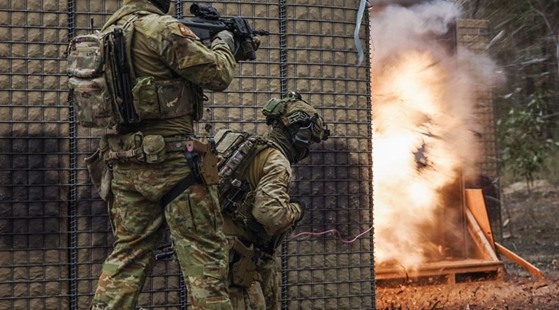 Australian soldiers explosively breach a method-of-entry training door during urban clearance training at Greenbank, Queensland. Photo by Corporal Janet Pan.