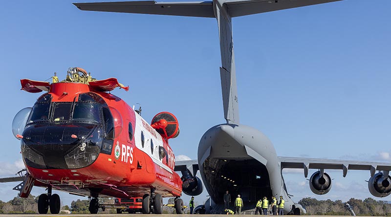 A NSW Rural Fire Service Boeing CH-47D Chinook heavy-lift helicopter is lined up with the ramp of a C-17A Globemaster bound for France at RAAF Base Richmond. Photo by Sergeant Dan Pinhorn.