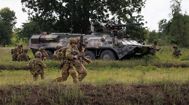 Australian Army soldiers from the 2/30 Training Group dismount from a Royal Thai Army BTR-3E1 armoured personnel carrier during mechanised trench assault training in Lop Buri Province, Thailand during Exercise Chapel Gold 26. Photo by Corporal Lachlan Campbell.