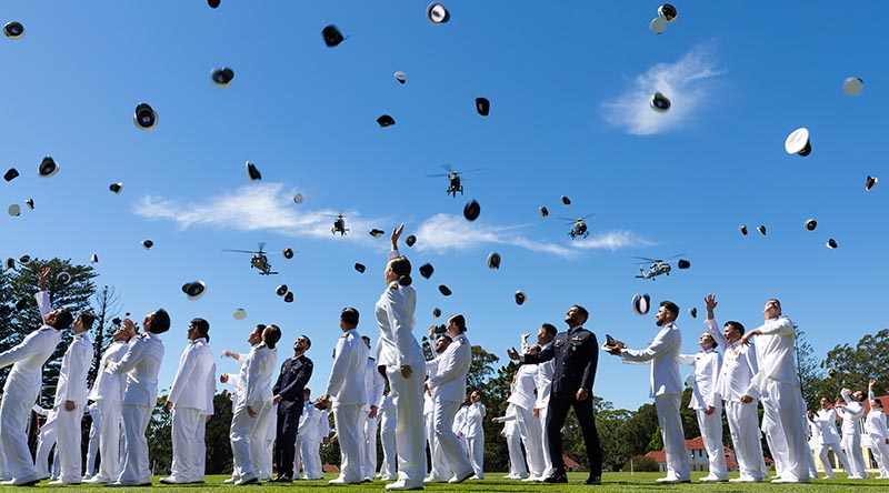 Graduates of the New Entry Officer Course 76 toss their caps in the air in celebration at end of their graduation parade at the Royal Australian Naval College, HMAS Creswell. Photo by Leading Seama Susan Mossop.