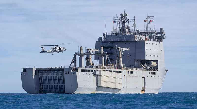 HMAS Supply’s embarked MH‑60R Seahawk helicopter conducts vertical replenishments between HMAS Supply and HMAS Choules while sailing off the coast of New South Wales, Australia during Regional Presence Deployment 2026. Photo by Able Seaman Jaxsen Shinners.