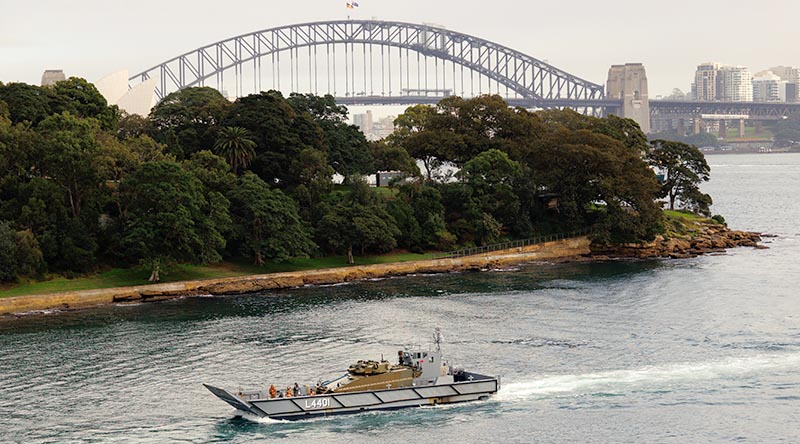 An AS21 Redback infantry fighting vehicle is transported on a Royal Australian Navy LCM-1E landing craft at Garden Island, Sydney Harbour. Photo by Sergeant Tristan Kennedy.