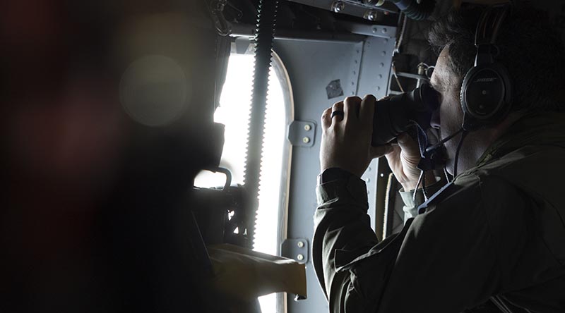 Royal Australian Air Force Flight Sergeant Samuel Fedderson conducts maritime surveillance on a C-27J Spartan aircraft over Solomon Islands' waters. Photo by Sergeant Samuel Miller.