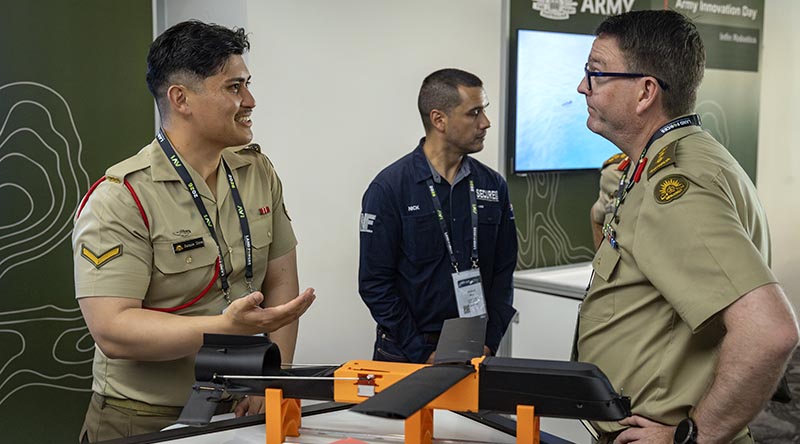 Australian Army soldier Lance Corporal Jamie Dow explains a system to Commander Army Battlelab Colonel Matthew Hodda at the Army Innovation Day stand during the 2026 Chief of Army Symposium. Photo by Corporal Michael Rogers.