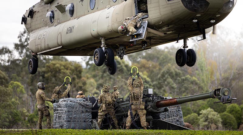 Australian Army soldiers from the 1st Regiment, Royal Australian Artillery prepare to attach a M777 to a CH-47 Chinook from the 5th Aviation Regiment as part of training activities at RAAF Base Amberley, Queensland. Photo by Gunner Jesse Linards.