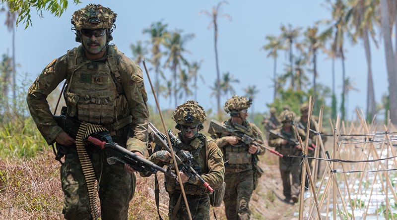 Australian Army soldiers prepare to clear an objective following an amphibious landing off HMAS Choules, at Banongan Beach, Indonesia, during Exercise Keris Woomera 2026. Photo by Captain Annie Richardson.