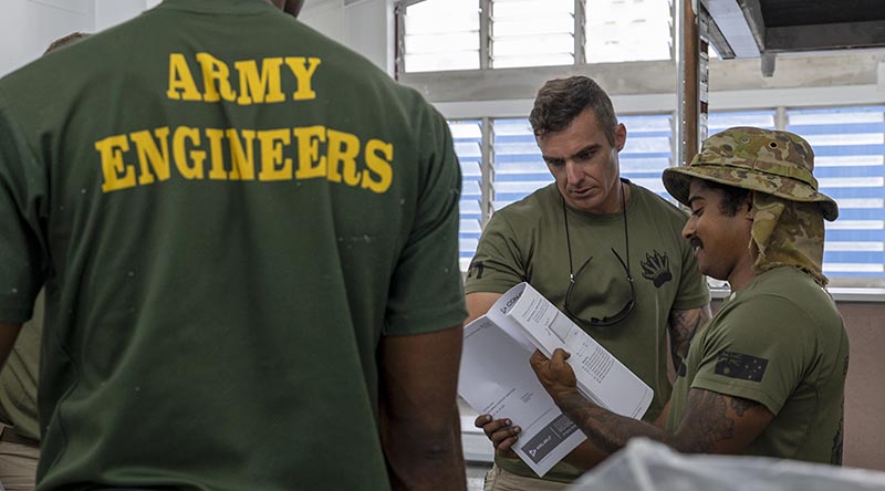Australian Army soldiers Corporal Kieren Thompson and Sapper Albert George from 3rd Combat Engineer Regiment review equipment instructions in the soldiers’ mess as part of Exercise Puk Puk at Igam Barracks, Lae, Papua New Guinea. Photo by Corporal Caitlyn Davill.