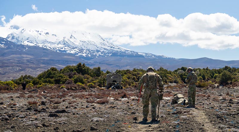 An Australian/New Zealand team begin to clear a safe path into an unexploded-ordnance-hazard zone with handheld metal detectors, during Exercise Safe Step in Waiouru, New Zealand. NZDF photo.