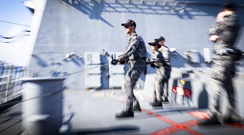 Members of HMAS Sydney (V) monitor the distance line during a replenishment at sea with HMNZS Aotearoa during transit through the South China Sea. Photo by Leading Seaman Lauren Pugsley.