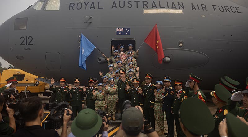 Vietnam People’s Army personnel farewell media before boarding a RAAF C-17A Globemaster III for their deployment to the United Nations Mission in South Sudan. Photo by Corporal Luke Bellman.