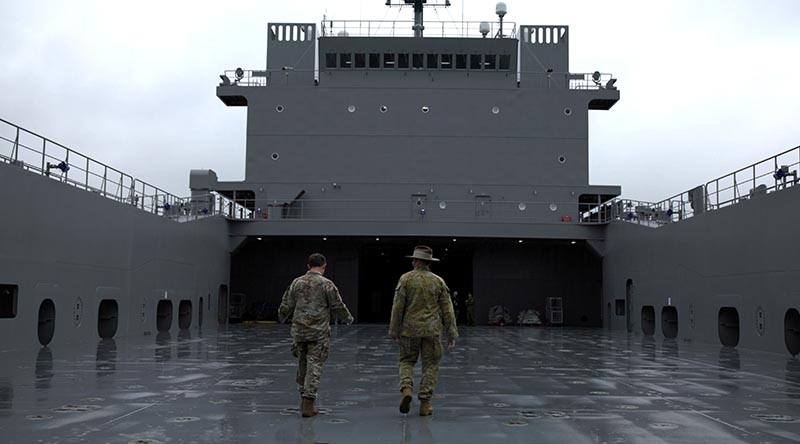 US Army and Australian Army soldiers discuss large landing-craft operations aboard a US Army Runnymede-class boat in Japan. Photo by Gunner Jesse Linards.